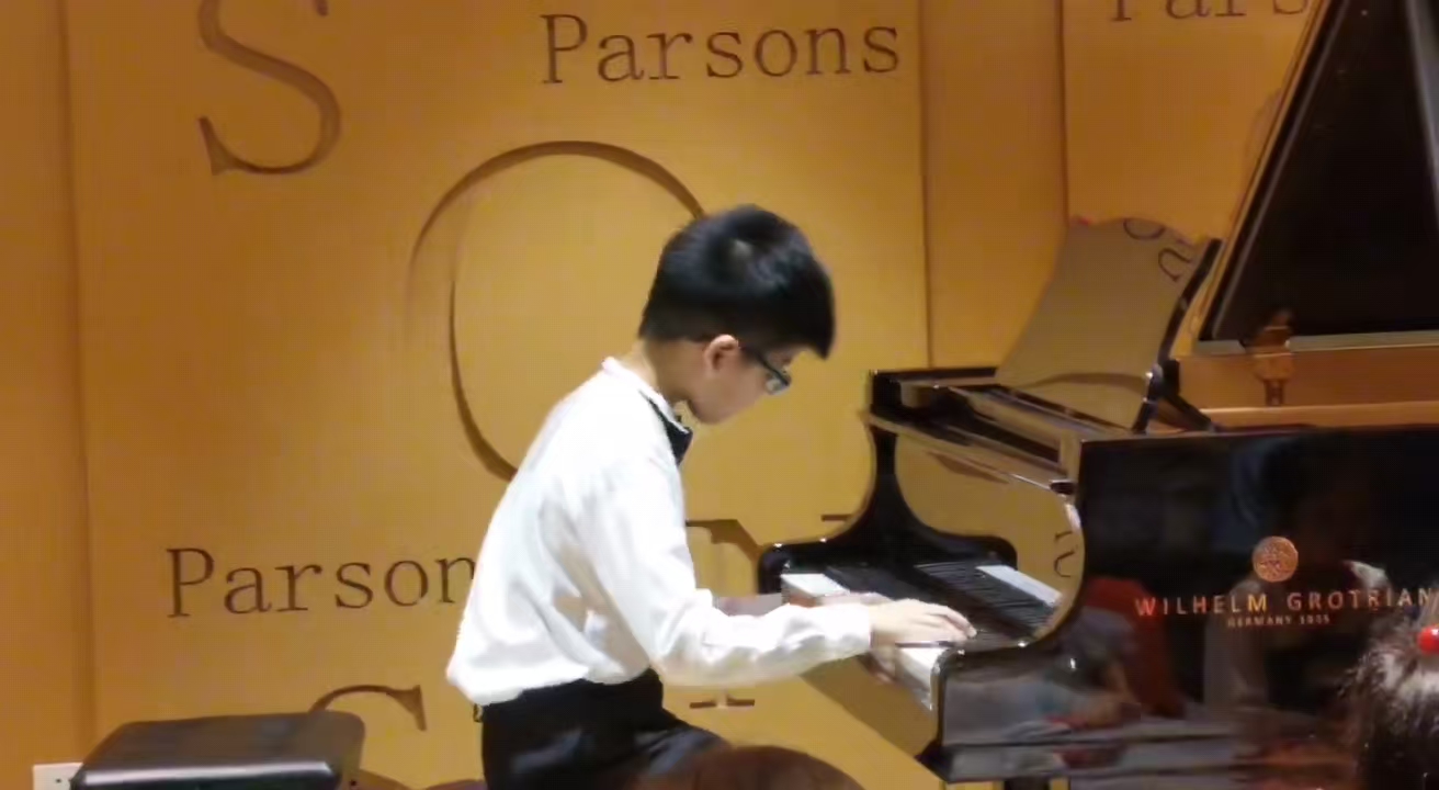 Zicong playing piano as a child